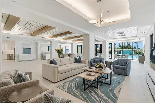 a living room with furniture ceiling fan and a rug