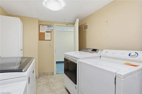 a view of a house with backyard and a tree