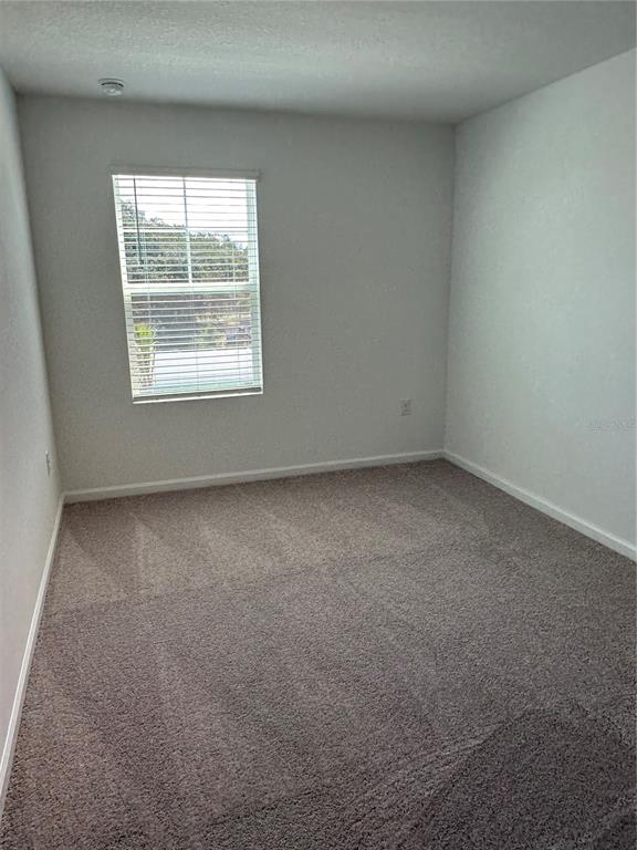 374 Cadberry Place St. Cloud, FL 34771 - Photo 9 of 11 an empty room with a window