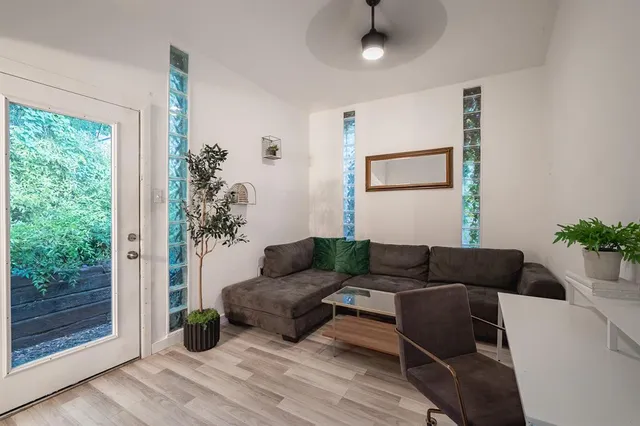 a living room with furniture and a potted plant