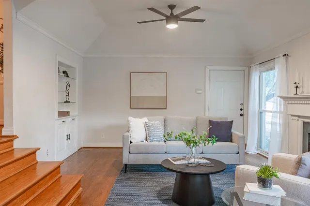 a living room with furniture and a wooden floor
