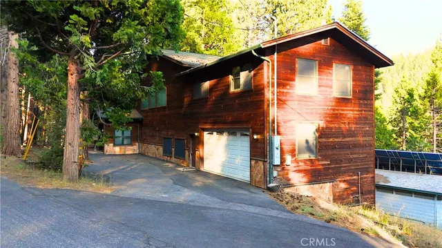 a view of a house with wooden fence
