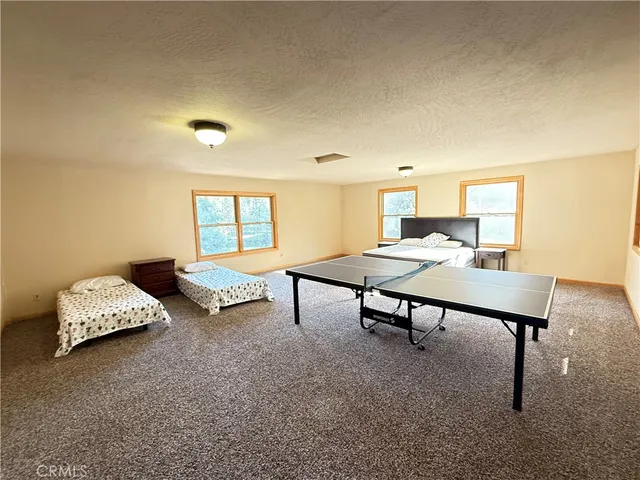 a blue house with trees in front of it