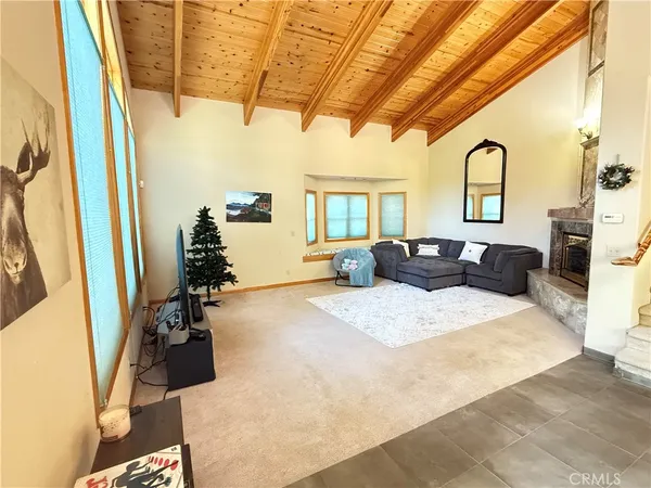 a view of a living room and kitchen with a large window