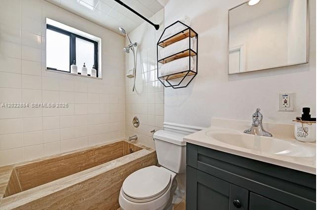 945 Sunset Road, Unit 1 West Palm Beach, FL 33401 - Photo 16 of 20 a bathroom with a sink a toilet and shower