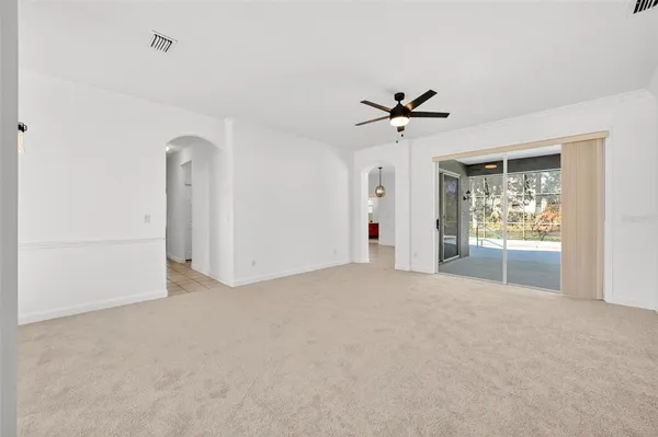 a view of a room with a ceiling fan and a window