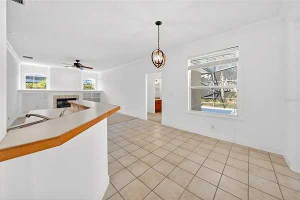 a view of empty room with kitchen view