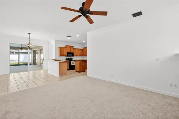 an empty room with windows and fireplace