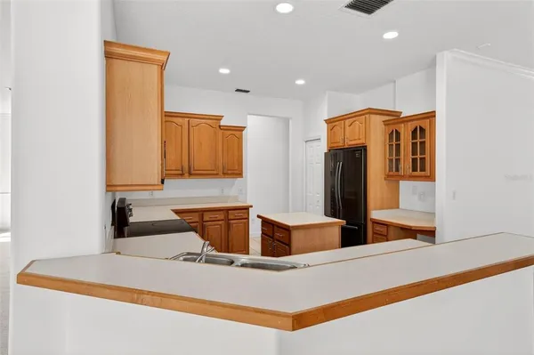 a bathroom with a granite countertop sink a toilet a mirror and shower