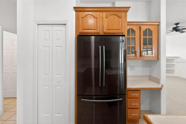 an empty room with a window and a ceiling fan