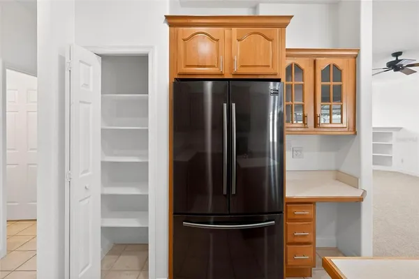 an empty room with a ceiling fan and a window