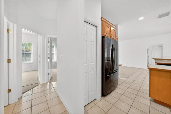 a utility room with a sink a cabinetry and a window