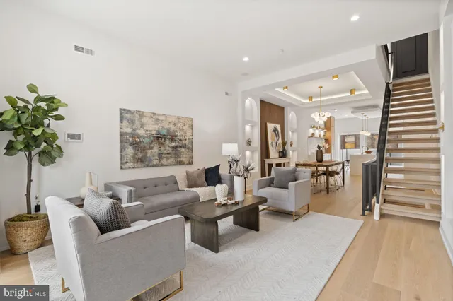 a living room with furniture and a potted plant