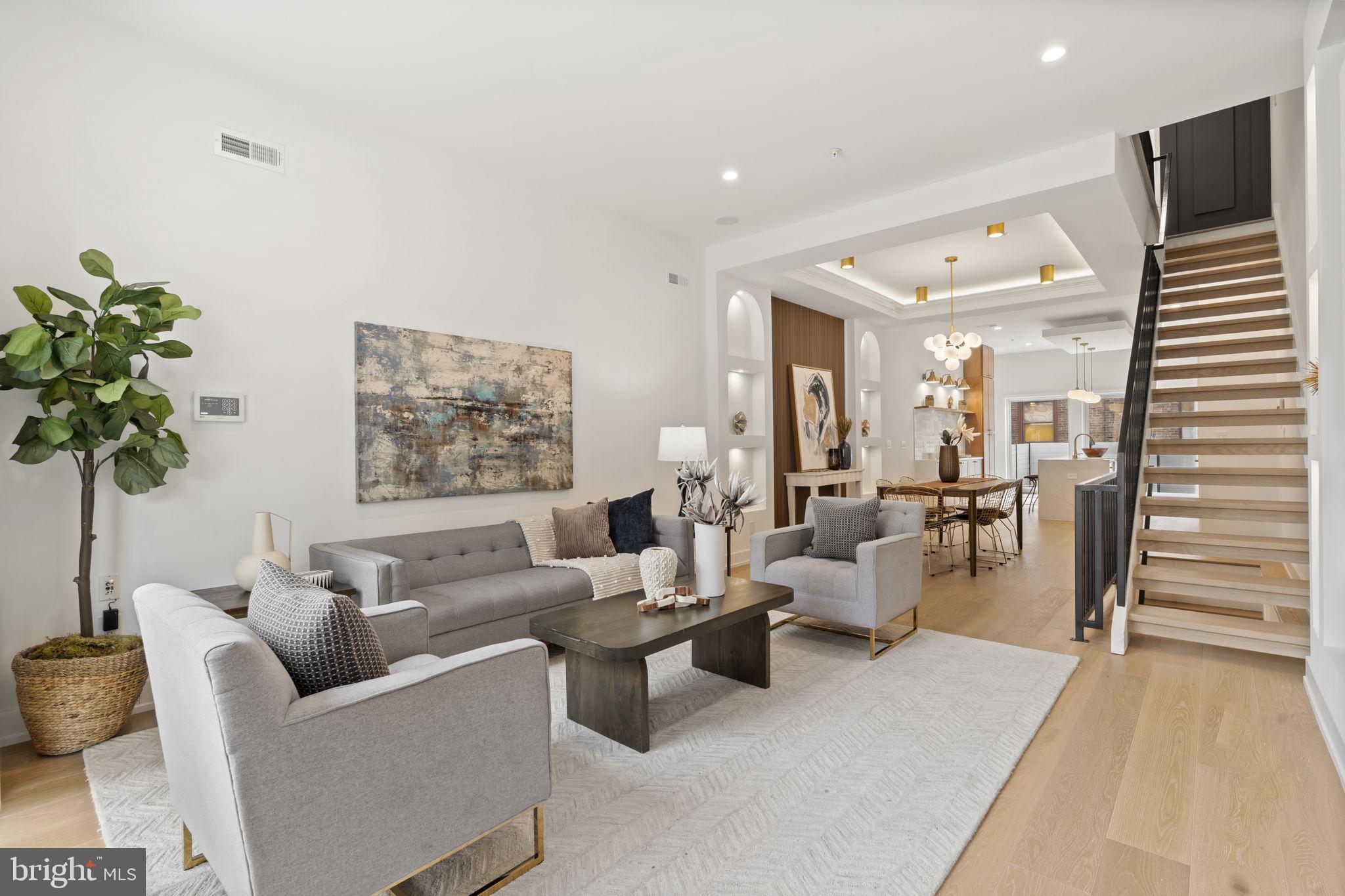 a living room with furniture and a potted plant