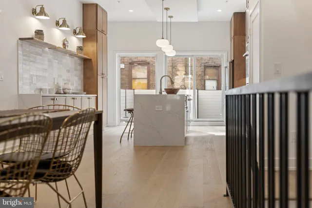 a large kitchen with stainless steel appliances lots of counter space and wooden floor