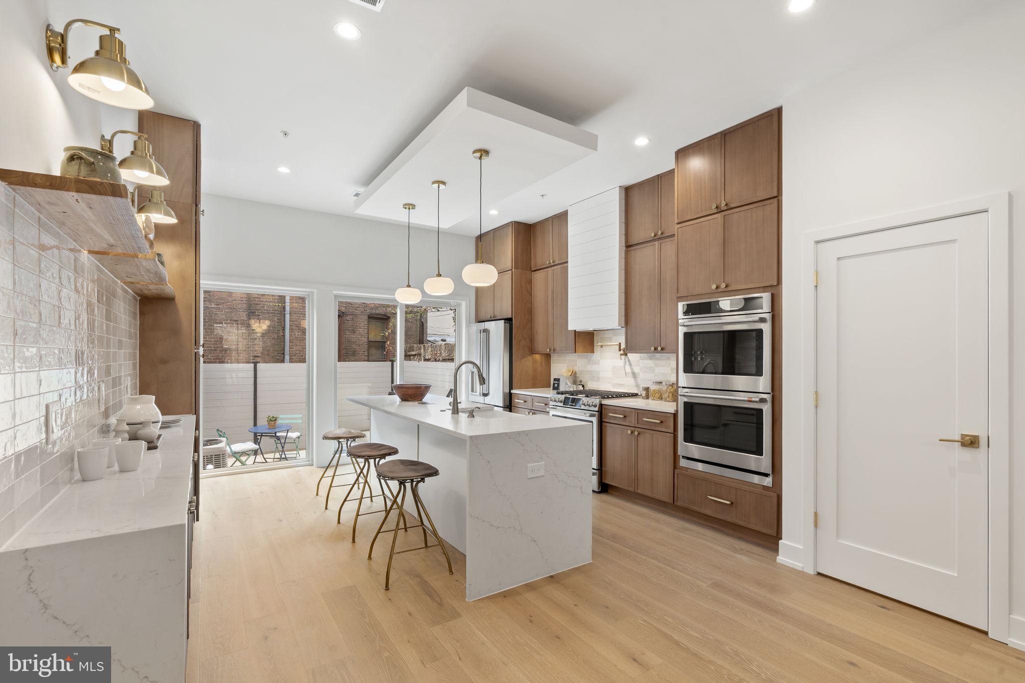 503 Winton Street Philadelphia, PA 19148 - Photo 15 of 65 a kitchen with stainless steel appliances a stove a sink a refrigerator and cabinets