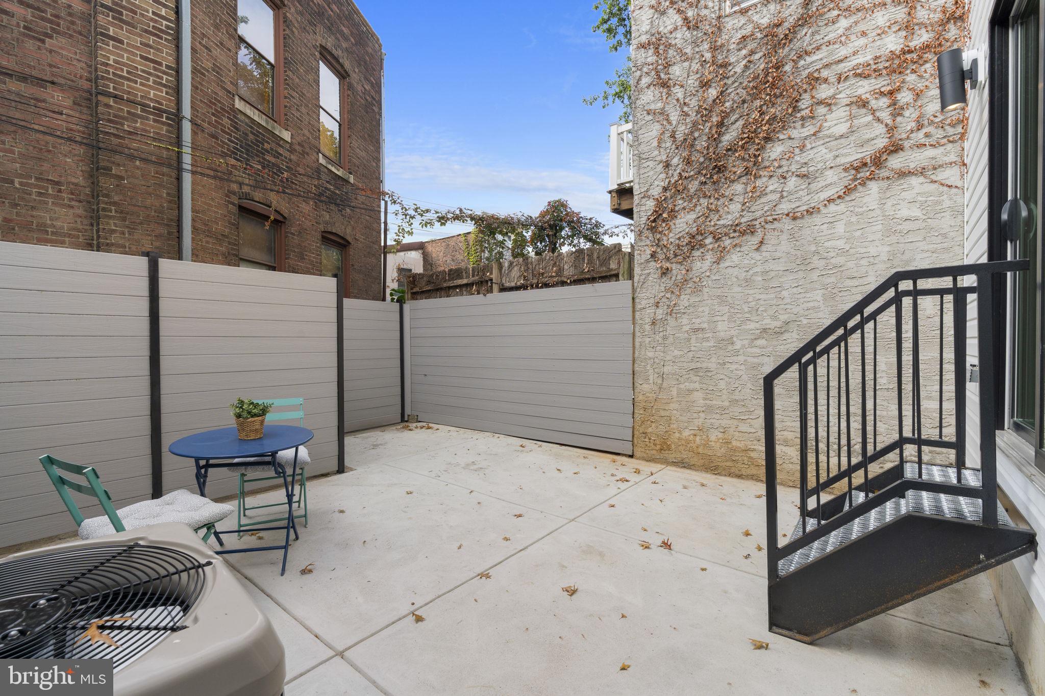 503 Winton Street Philadelphia, PA 19148 - Photo 22 of 65 a backyard of a house with table and chairs