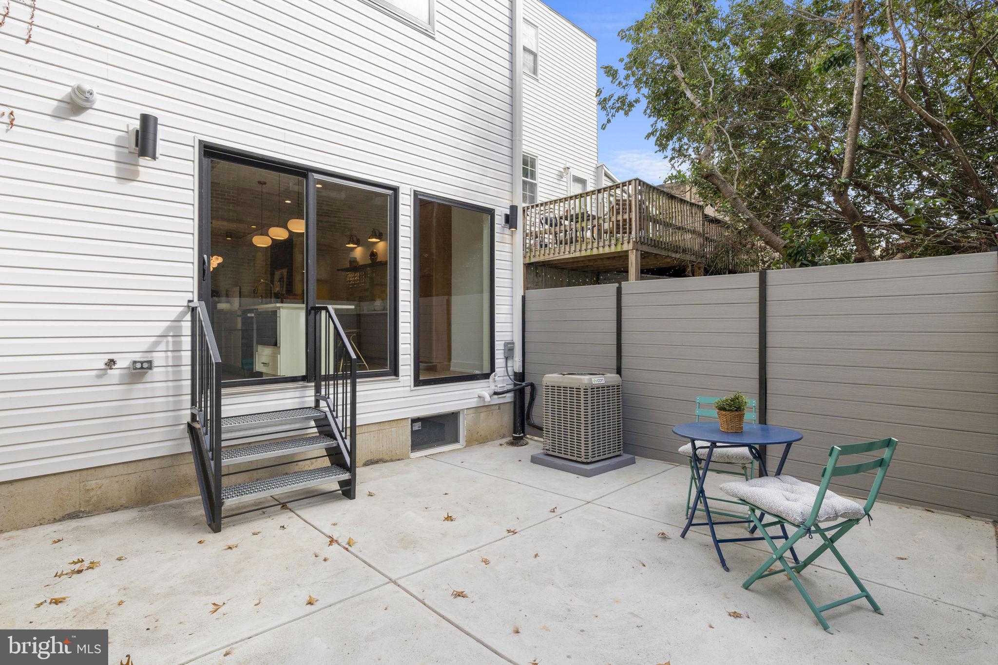 503 Winton Street Philadelphia, PA 19148 - Photo 23 of 65 a view of a patio with a table and chairs and wooden floor