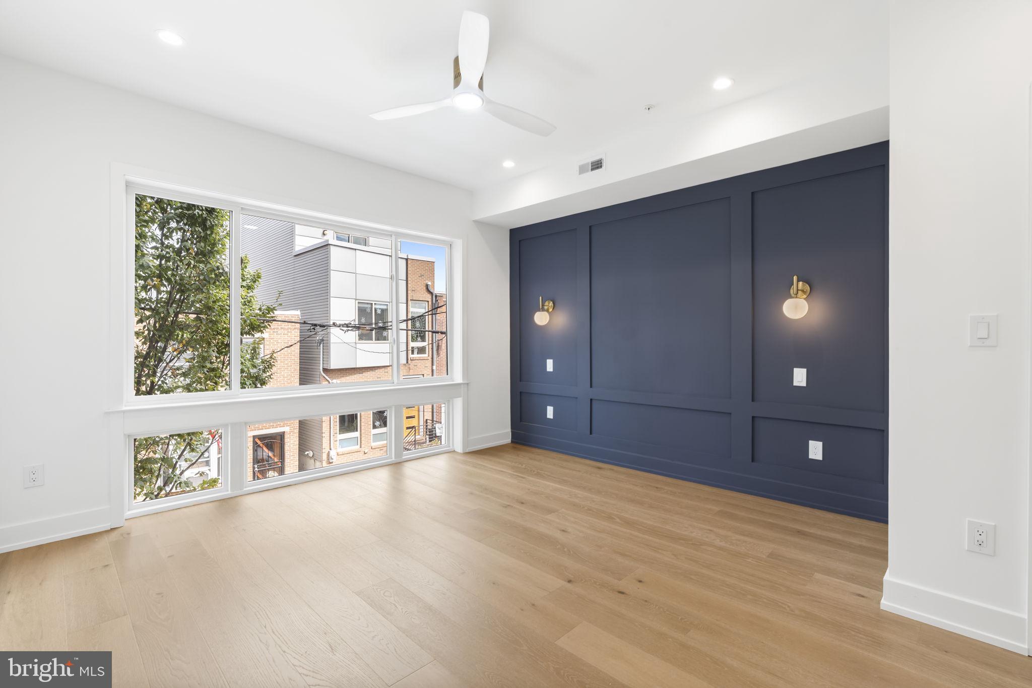 503 Winton Street Philadelphia, PA 19148 - Photo 31 of 65 a view of an empty room with a window and wooden floor