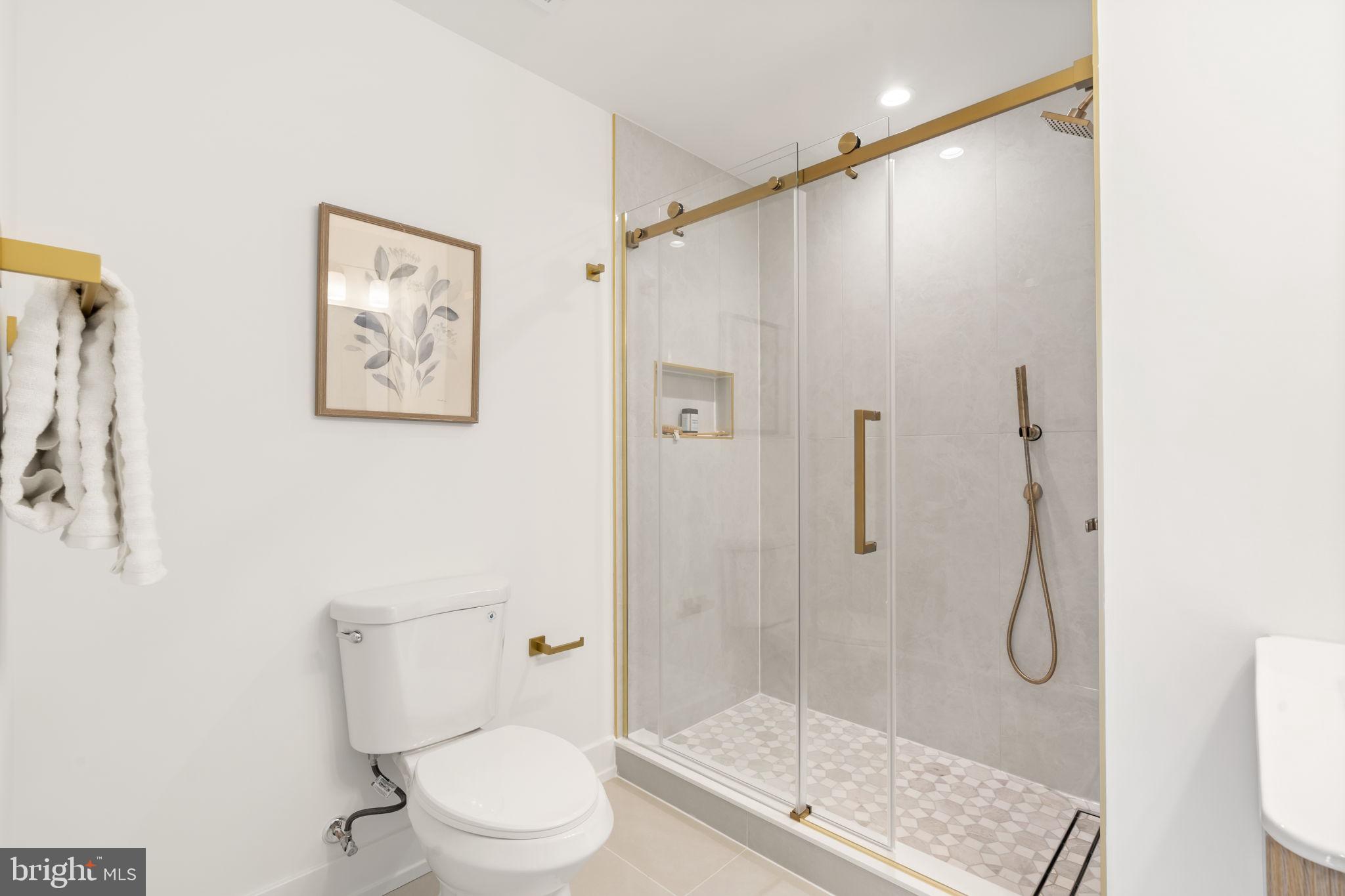 503 Winton Street Philadelphia, PA 19148 - Photo 33 of 65 a bathroom with a glass shower door