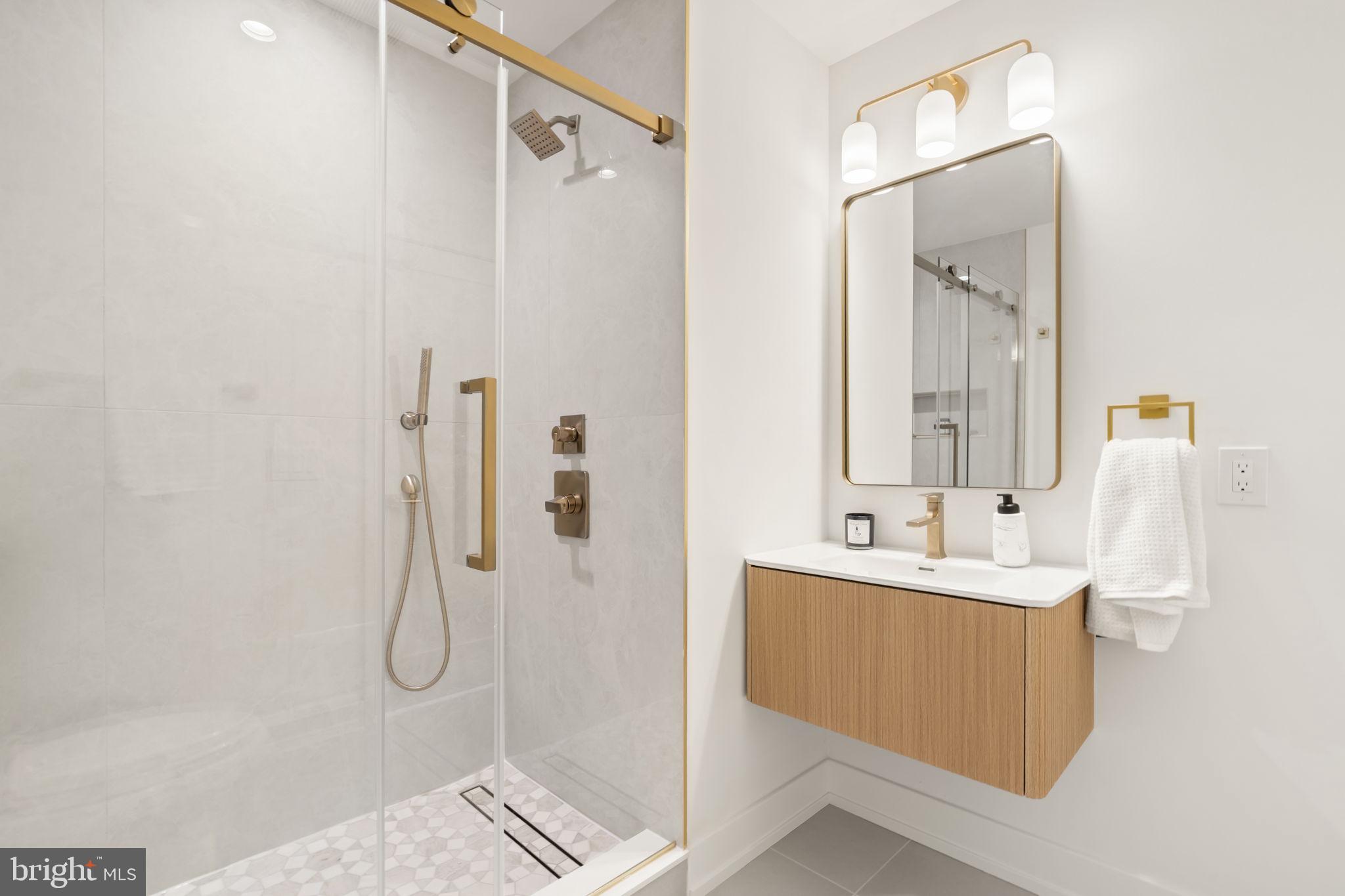 503 Winton Street Philadelphia, PA 19148 - Photo 34 of 65 a bathroom with a double vanity sink a mirror and shower