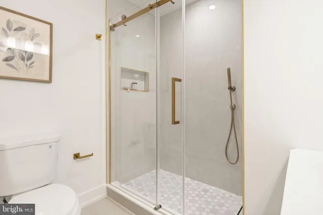 a spacious bathroom with a double vanity sink mirror and shower
