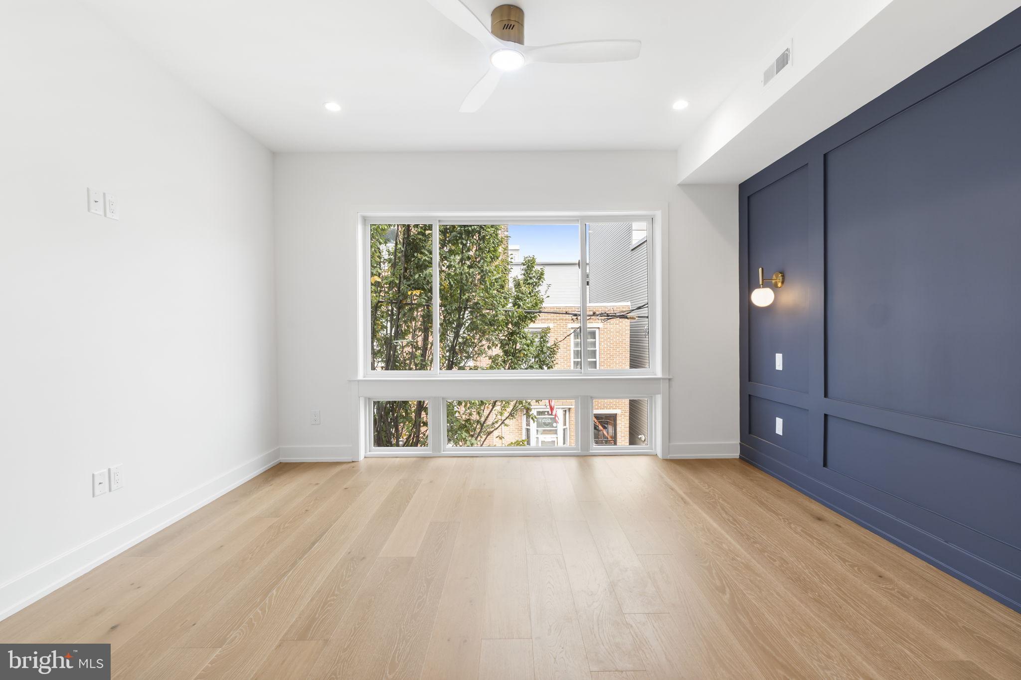 503 Winton Street Philadelphia, PA 19148 - Photo 36 of 65 a view of an empty room with window and wooden floor