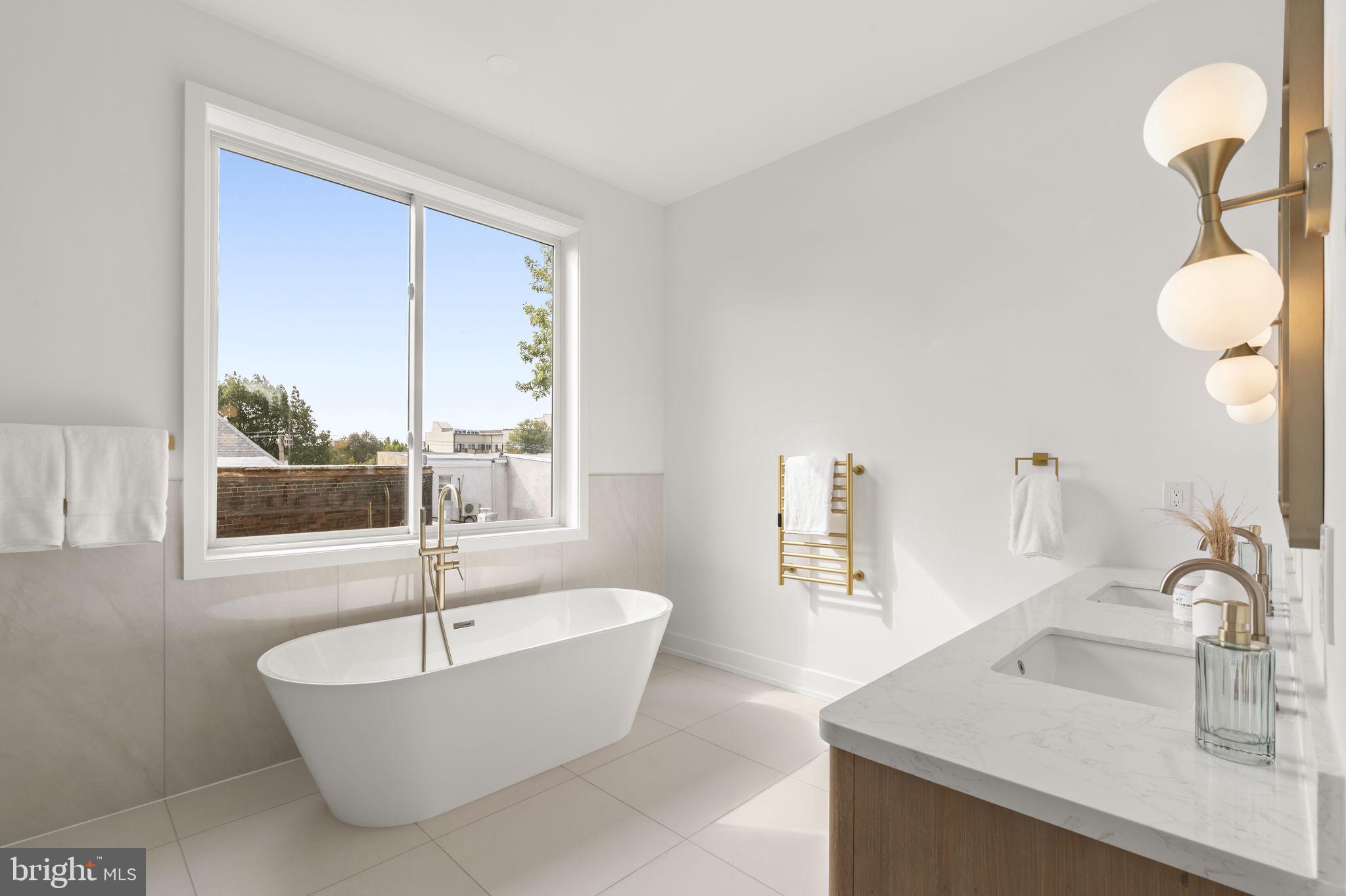 503 Winton Street Philadelphia, PA 19148 - Photo 44 of 65 a bathroom with a bathtub and next to a window