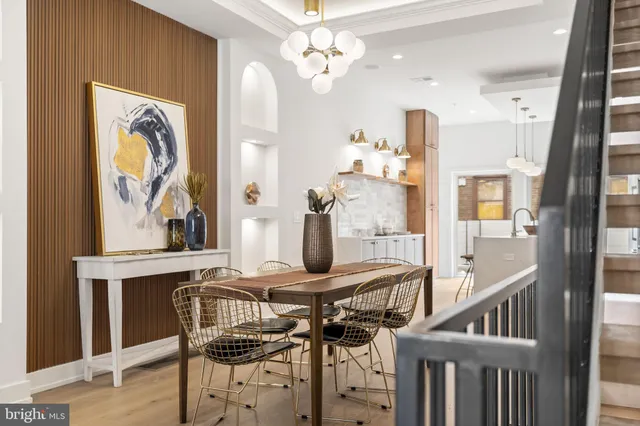 a view of a dining room with furniture and chandelier