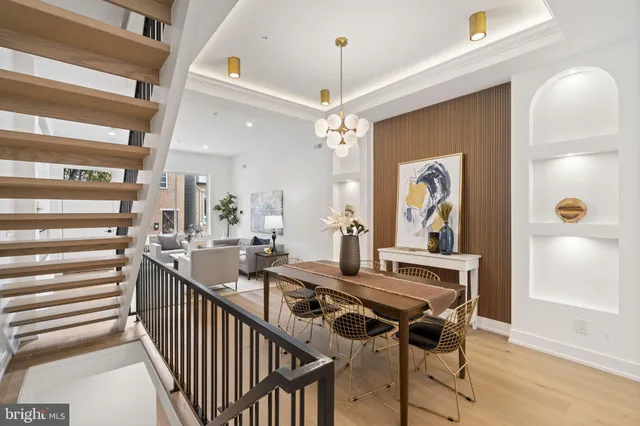 a view of a dining room with furniture and a chandelier
