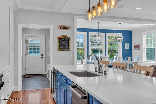 a kitchen with a sink a counter and cabinets