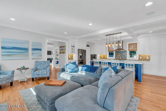 a living room with furniture and kitchen view
