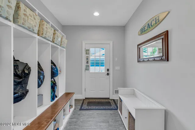 a hallway with painting and a lamp