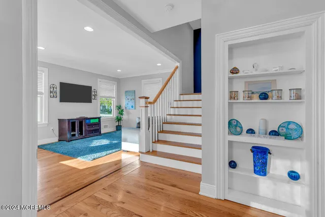 a living room with furniture and a fireplace with wooden floor