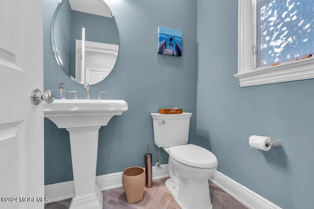 a bathroom with a toilet sink and mirror