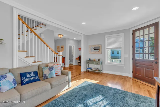 a living room with furniture and a hard wood floor