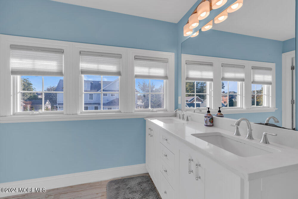 300 Salem Avenue Spring Lake, NJ 07762 - Photo 29 of 52 a bathroom with double vanity and a large mirror