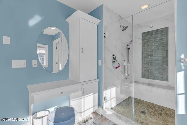 a bathroom with a shower a mirror and a toilet