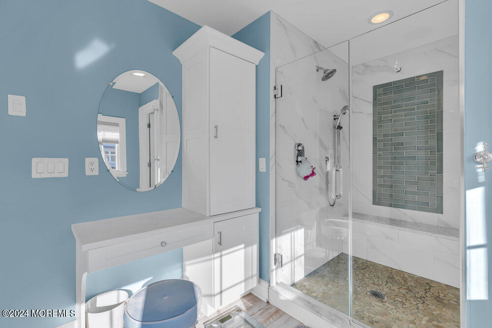 300 Salem Avenue Spring Lake, NJ 07762 - Photo 30 of 52 a bathroom with a shower a mirror and a toilet