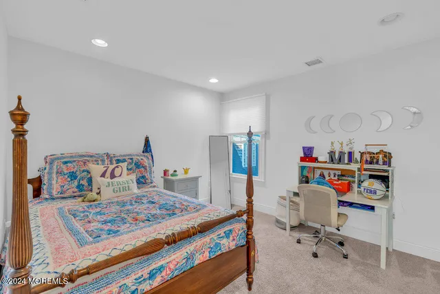 a bed room with a bed and a book shelf