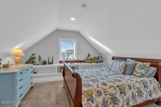 a bathroom with a granite countertop sink toilet a mirror and a window