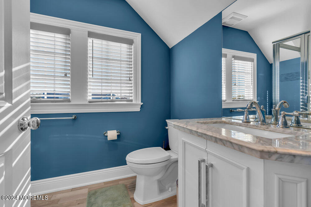 300 Salem Avenue Spring Lake, NJ 07762 - Photo 43 of 52 a bathroom with a granite countertop sink toilet a mirror and a window