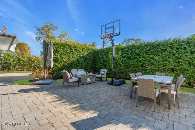 a backyard of a house with table and chairs