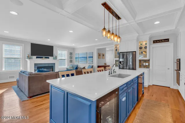 a large kitchen with sink a counter top space and stainless steel appliances