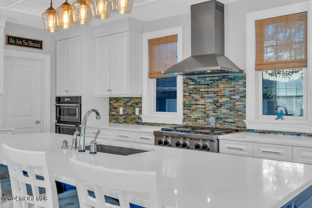 a kitchen with stainless steel appliances a sink and a stove