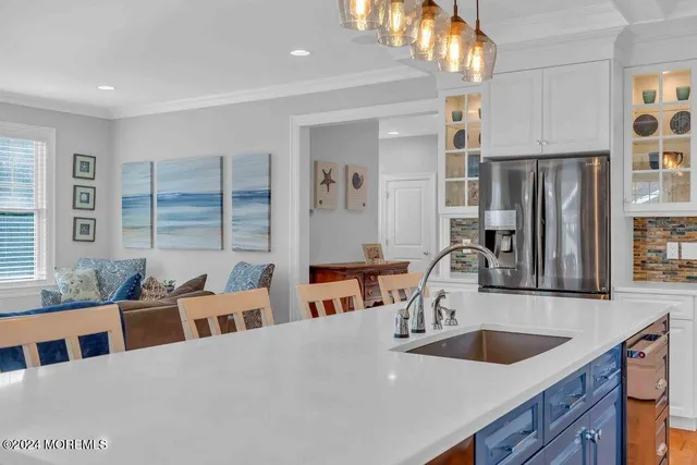 a kitchen with stainless steel appliances a sink and a refrigerator