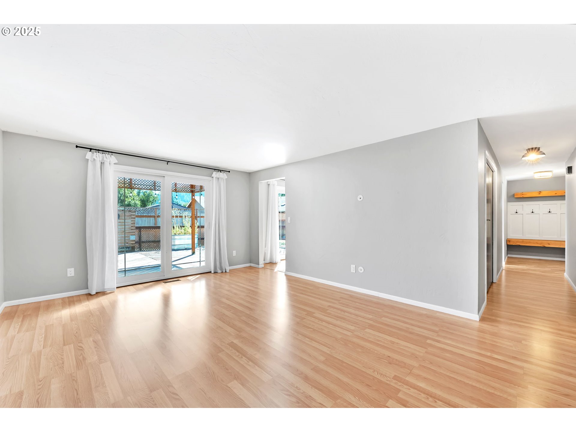 6781 F Street Springfield, OR 97478 - Photo 21 of 48 a view of an empty room with wooden floor and a window