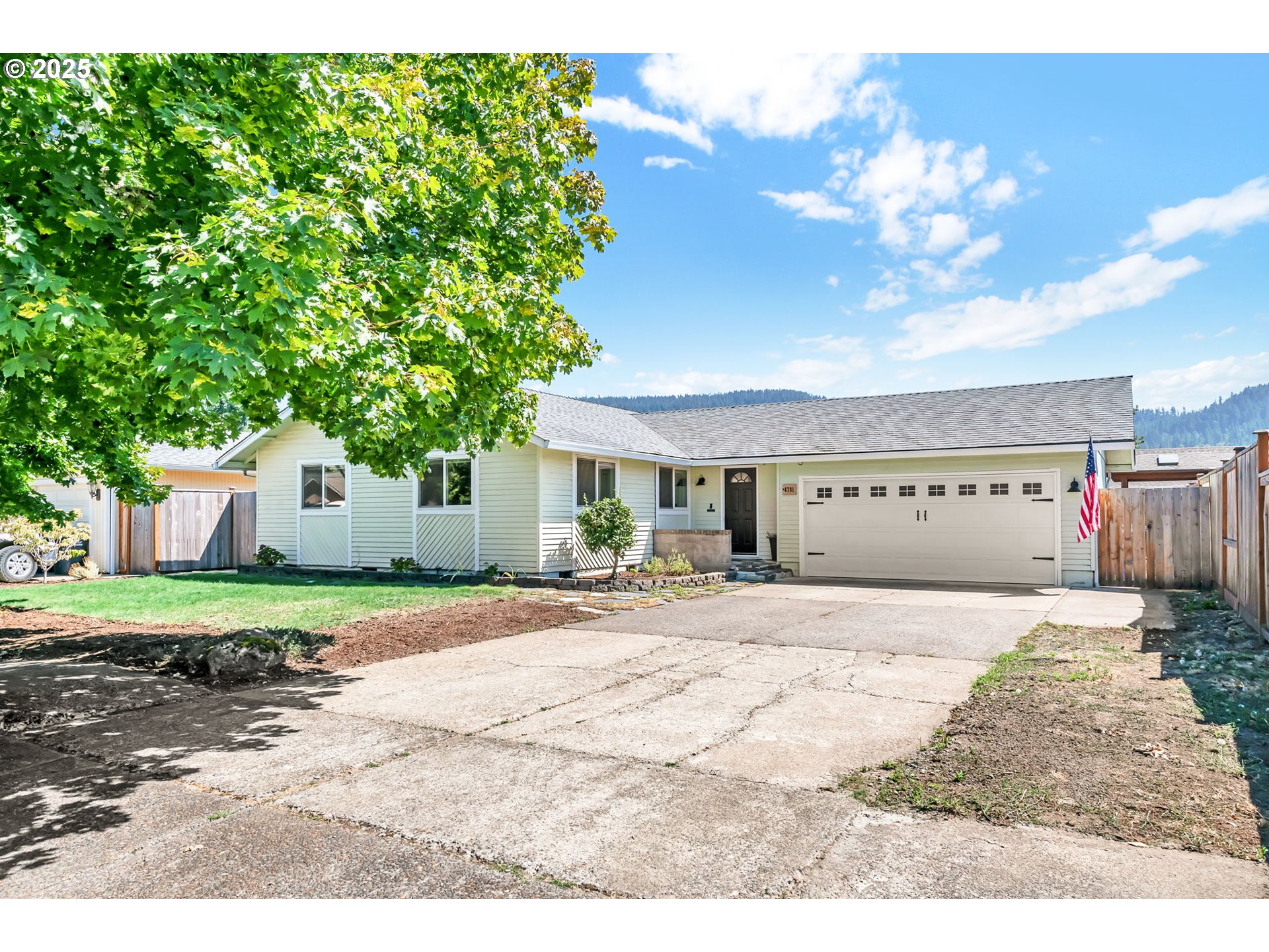 6781 F Street Springfield, OR 97478 - Photo 3 of 48 a view of a house with a yard and a large tree
