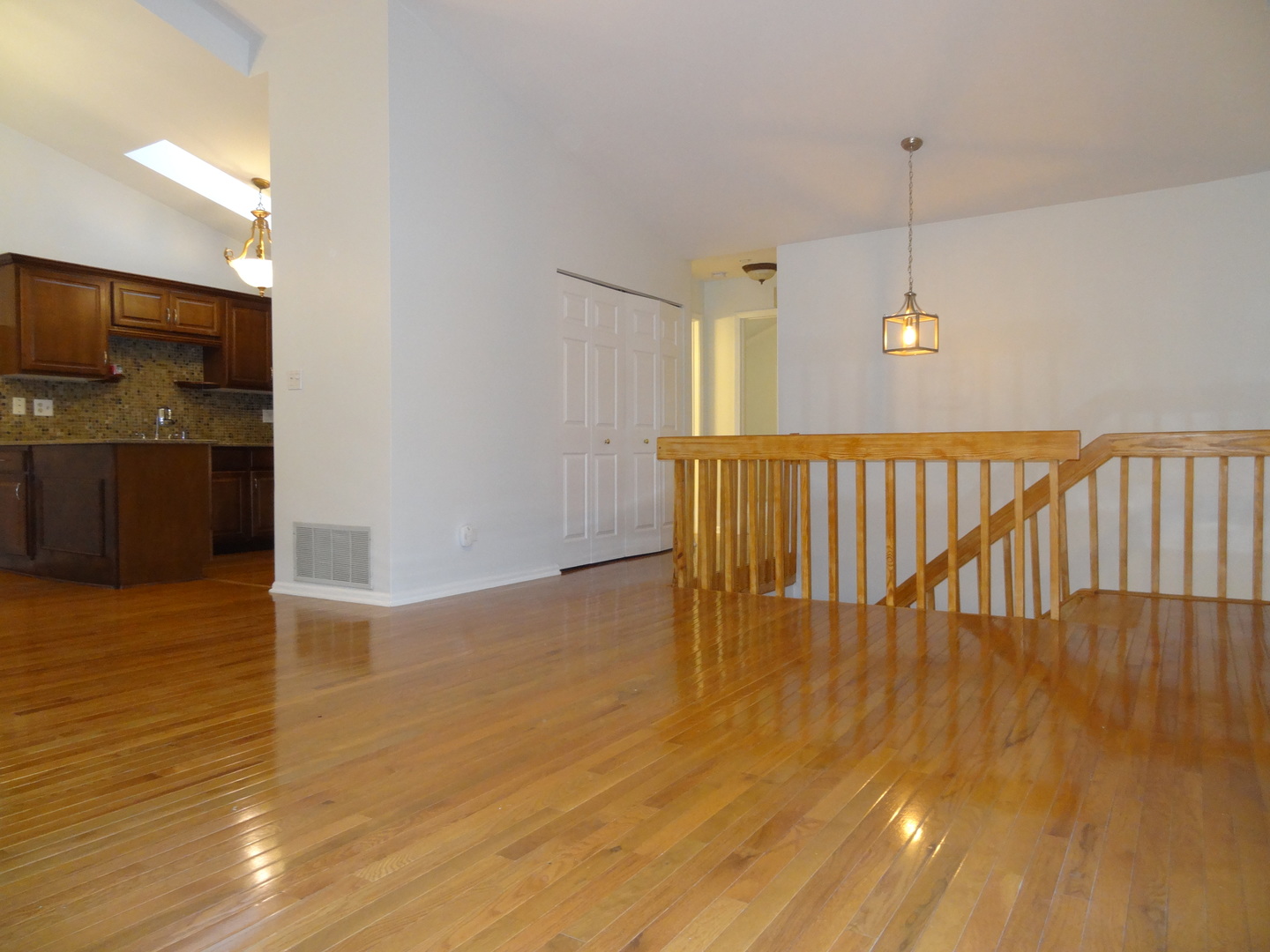 450 Bridle Trail, Unit 450 Wheeling, IL 60090 - Photo 2 of 15 a view of an empty room with wooden floor and a window