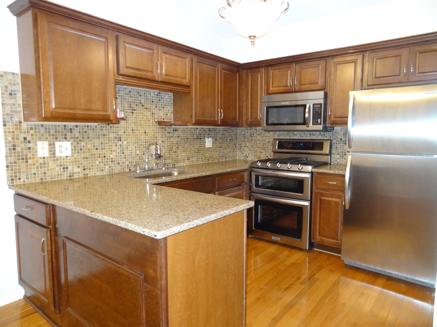 450 Bridle Trail, Unit 450 Wheeling, IL 60090 - Photo 6 of 15 a kitchen with stainless steel appliances granite countertop a sink stove and refrigerator